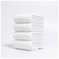Stack of folded disposable white waffle-texture towels