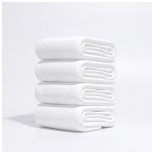 Stack of folded disposable white waffle-texture towels - alternate view
